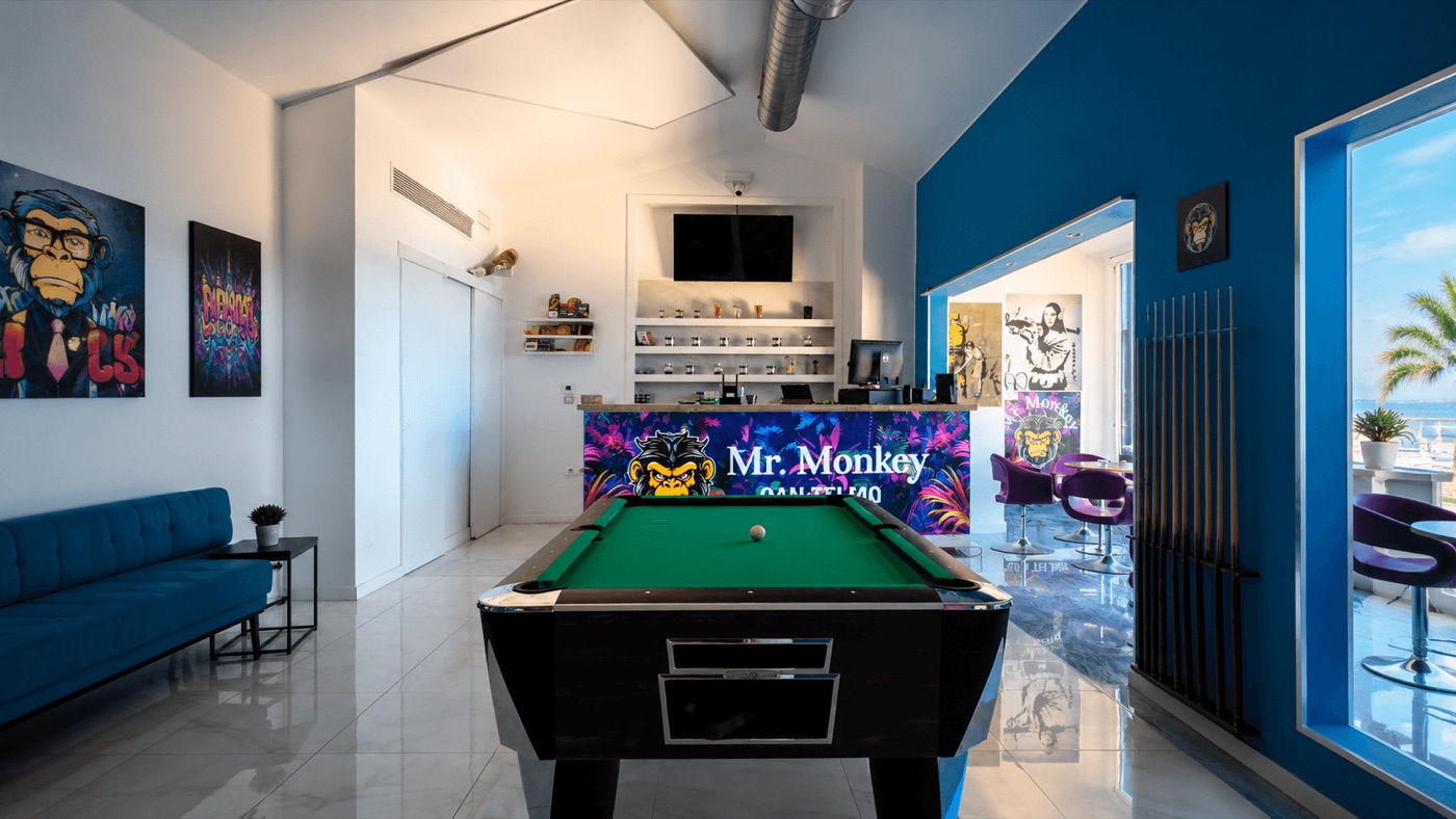 Inside Mr. Monkey Club 2: pool table, workspace and blue lounge
